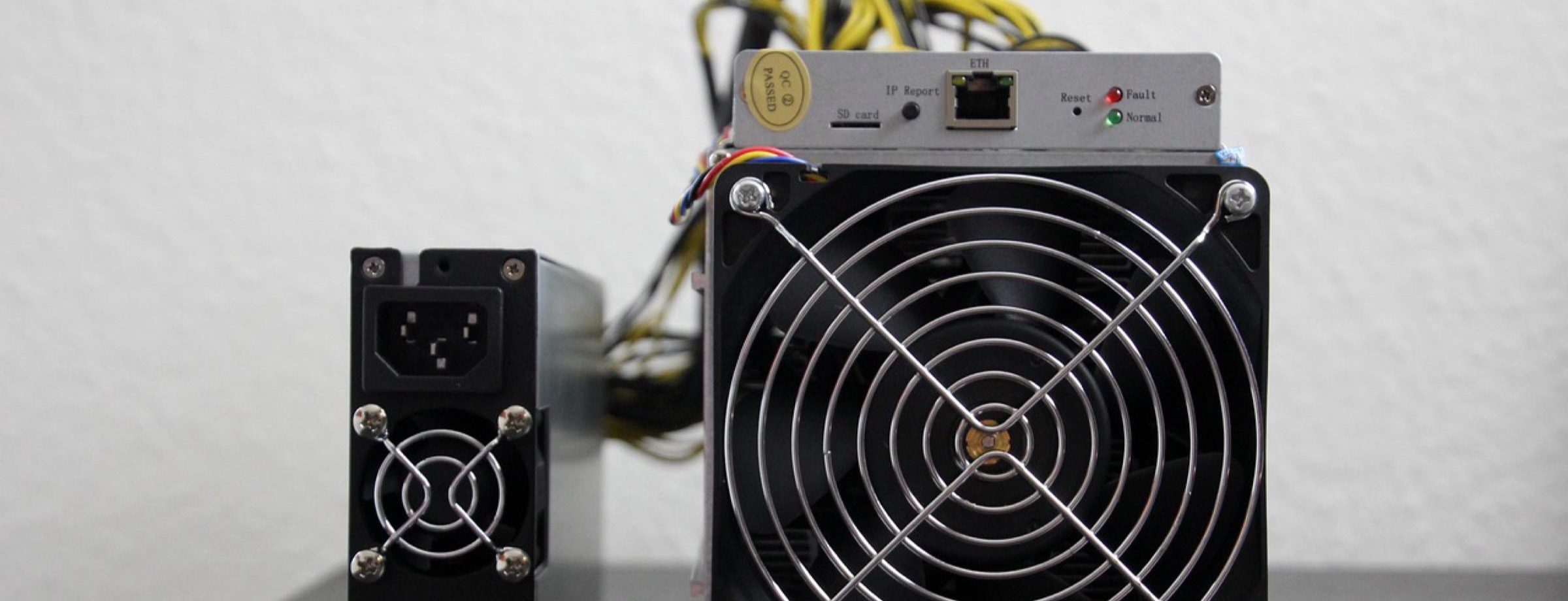 Antminer and its power supply on a service bench