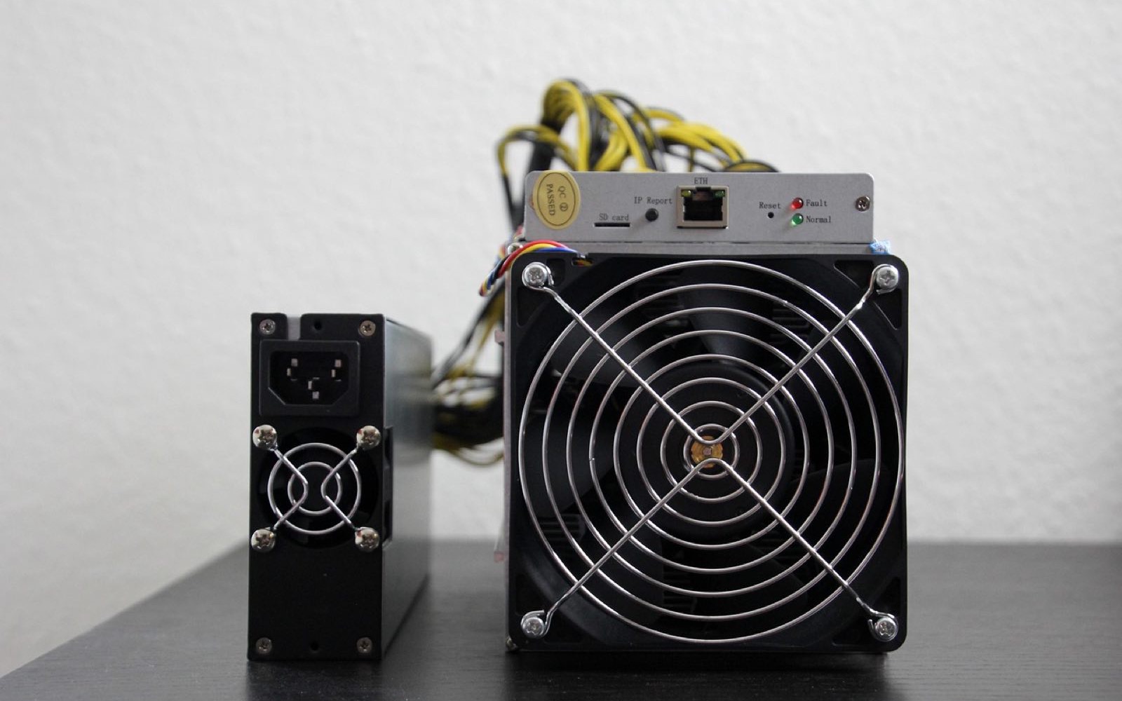 Antminer and its power supply on a service bench